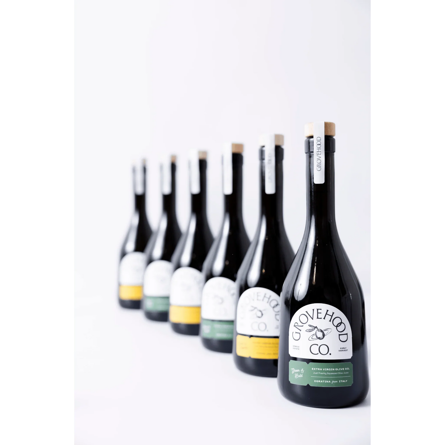 Grovehood Collective Extra Virgin Olive Oil bottles in a row