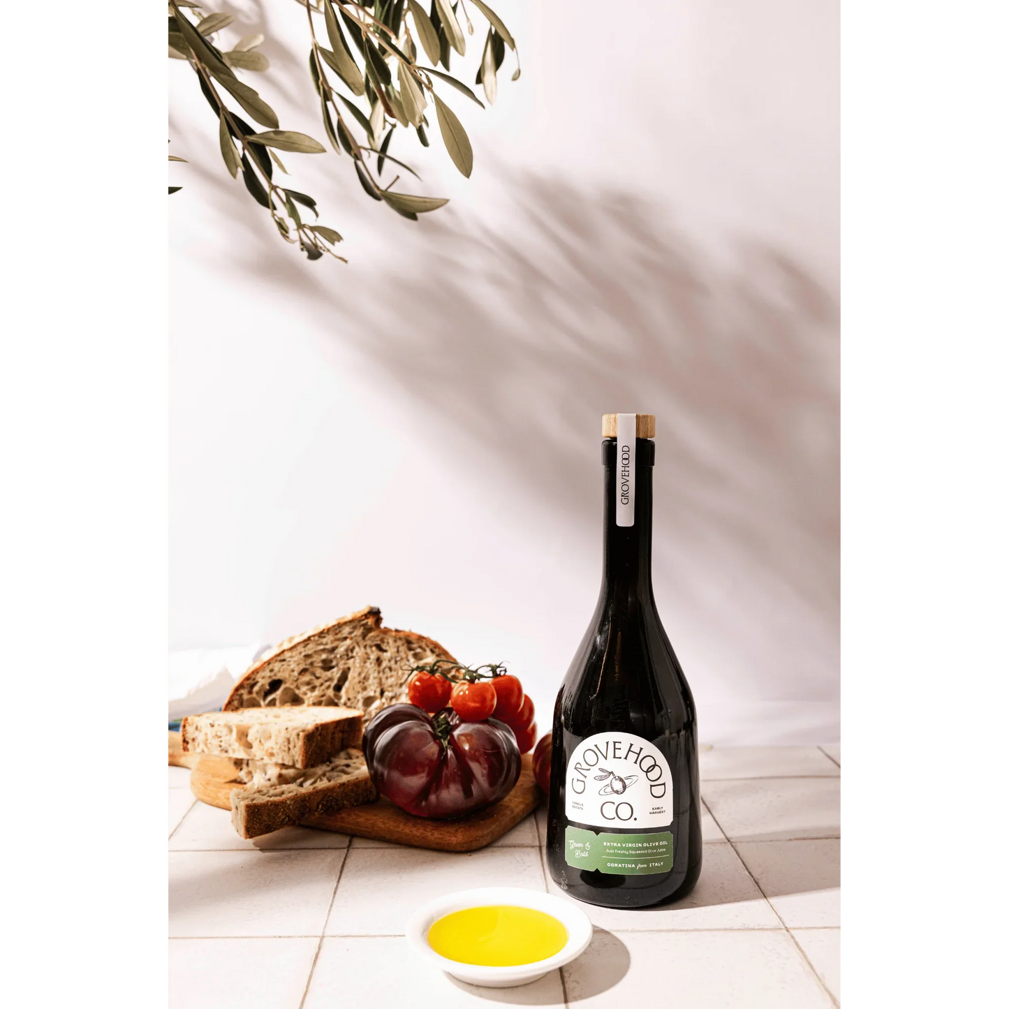 Grovehood Collective Italian extra virgin olive oil bottle with bread and tomatoes