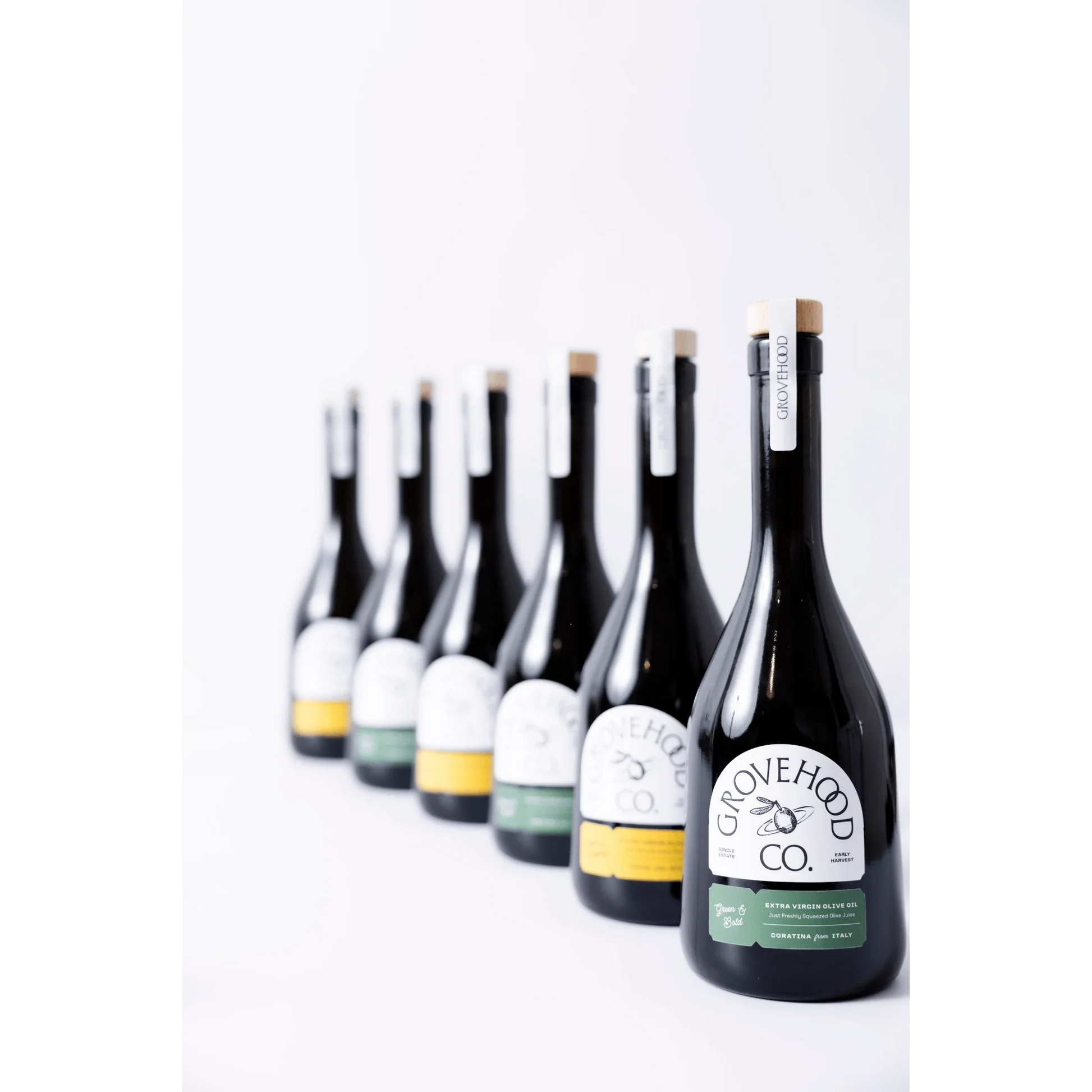 Grovehood Collective Extra Virgin Olive Oil bottles in a row