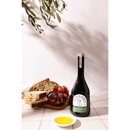 Grovehood Collective Italian extra virgin olive oil bottle with bread and tomatoes