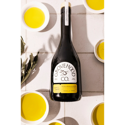 Grovehood Collective Spanish extra virgin olive oil bottle laid flat on a tile